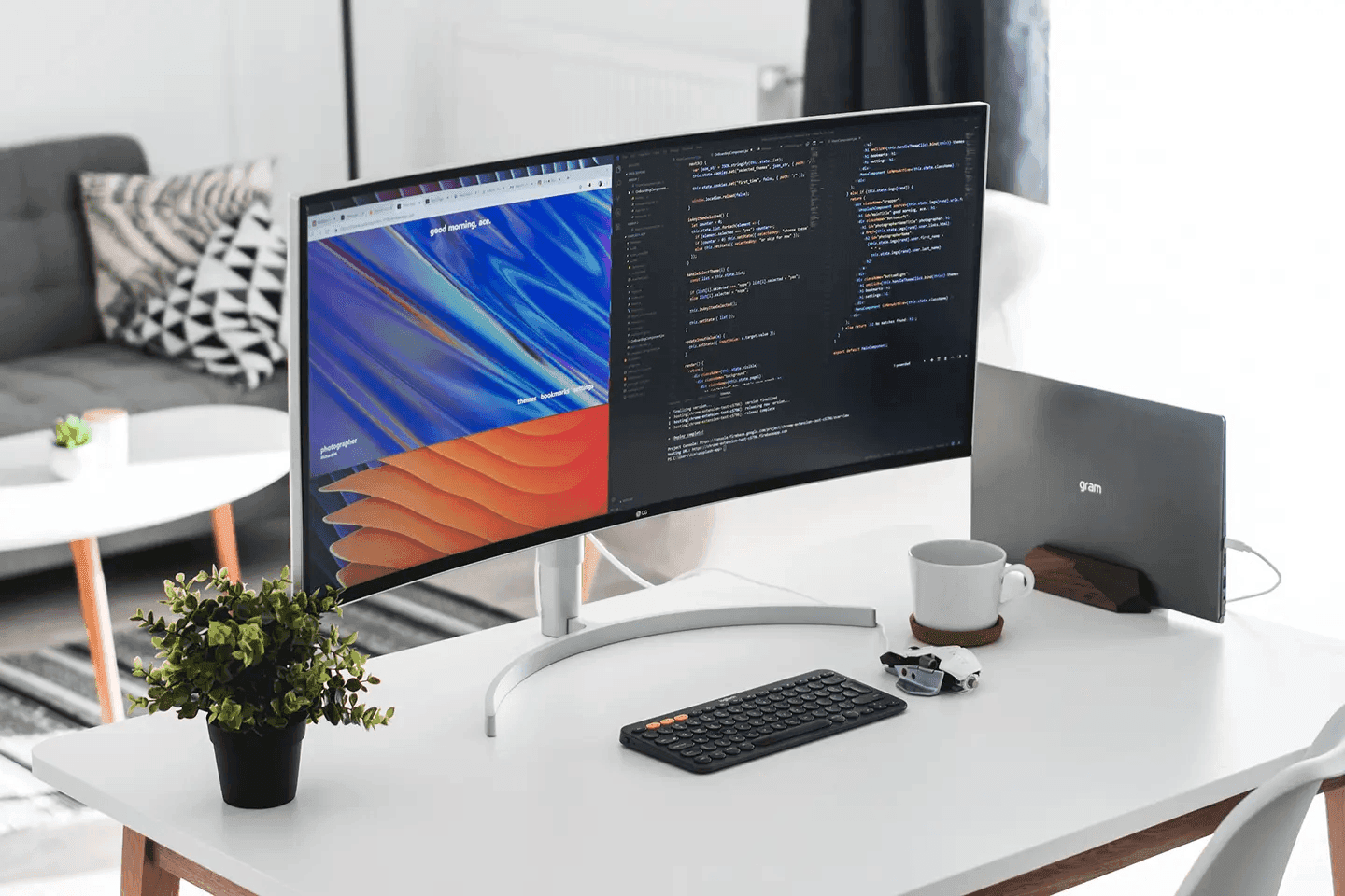 A modern workspace is set up with a curved monitor displaying code and a website with the title 'good morning, dia'. The desk is clean and minimalist, with a laptop, keyboard, and a small plant adding a touch of life. The overall mood is calm and productive, perfect for a day of coding or creative work.